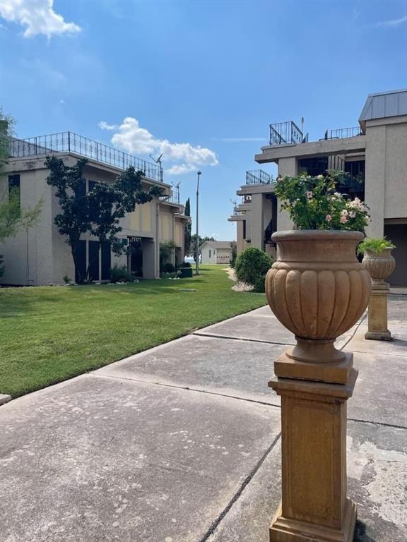 5804 Circulo Drive, Unit 5E Lago Vista, TX 78645 - Photo 8 of 12 a front view of a house with garden