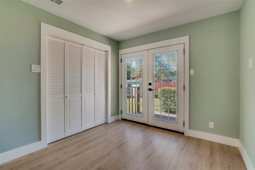 9209 Rustown Drive Dallas, TX 75228 - Photo 12 of 28 an empty room with wooden floor and windows