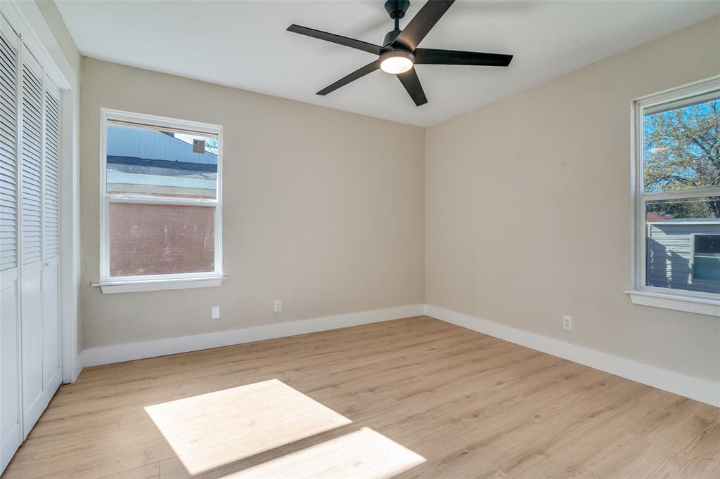 9209 Rustown Drive Dallas, TX 75228 - Photo 15 of 28 an empty room with a window and a fan