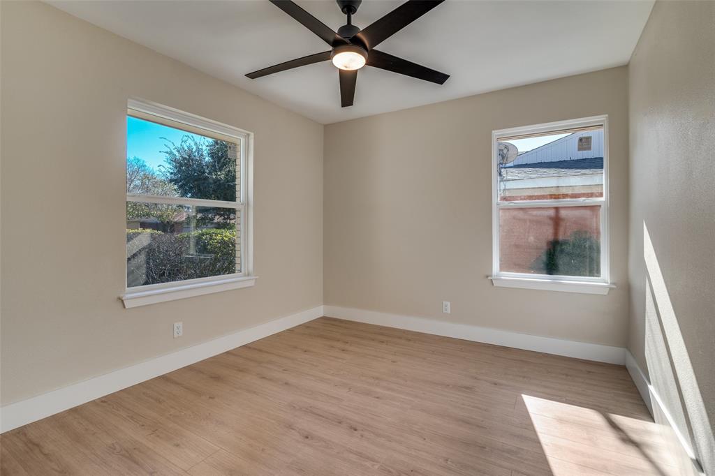 9209 Rustown Drive Dallas, TX 75228 - Photo 18 of 28 a view of an empty room with wooden floor and a window