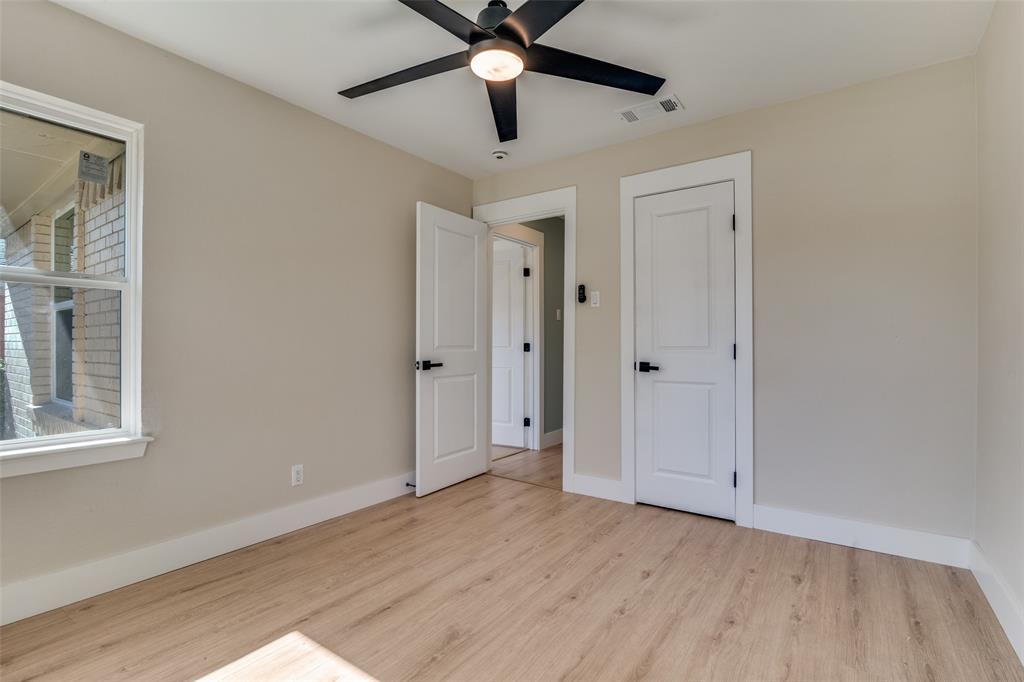 9209 Rustown Drive Dallas, TX 75228 - Photo 19 of 28 a view of an empty room with window and wooden floor