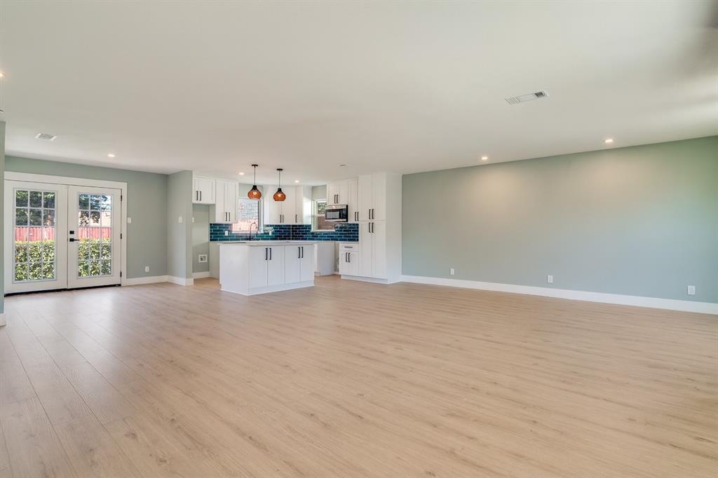 9209 Rustown Drive Dallas, TX 75228 - Photo 2 of 28 a view of a kitchen with furniture and wooden floor