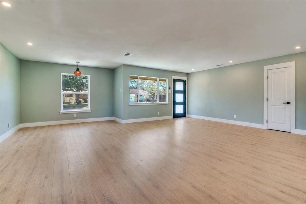 9209 Rustown Drive Dallas, TX 75228 - Photo 5 of 28 a view of a big room with wooden floor and windows