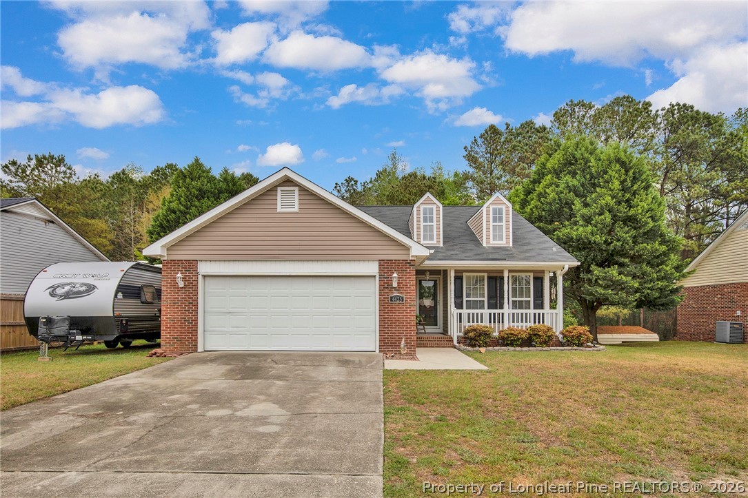 4425 Bishamon Street Hope Mills, NC 28348 - Photo 1 of 39 a view of a house with a yard and large trees