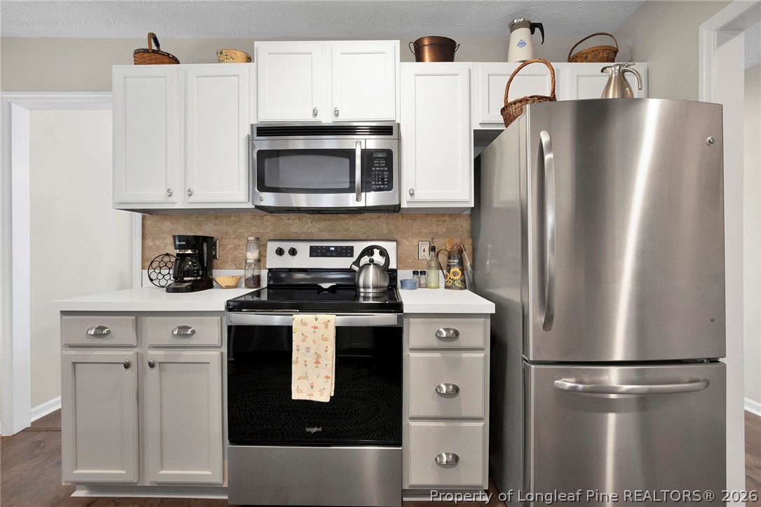 4425 Bishamon Street Hope Mills, NC 28348 - Photo 12 of 39 a kitchen with stainless steel appliances a refrigerator a stove a microwave and cabinets