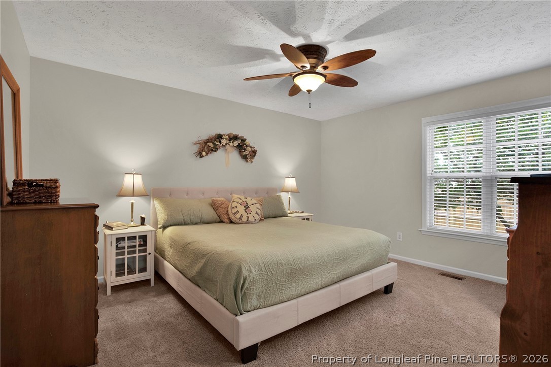 4425 Bishamon Street Hope Mills, NC 28348 - Photo 18 of 39 a bedroom with a bed and a window