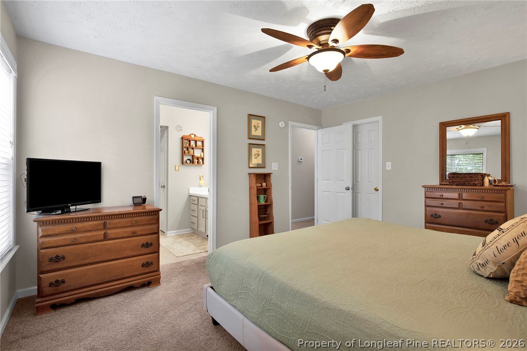 4425 Bishamon Street Hope Mills, NC 28348 - Photo 19 of 39 a bedroom with a bed and a flat screen tv