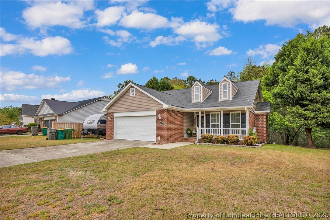 4425 Bishamon Street Hope Mills, NC 28348 - Photo 2 of 39 a front view of a house with a yard