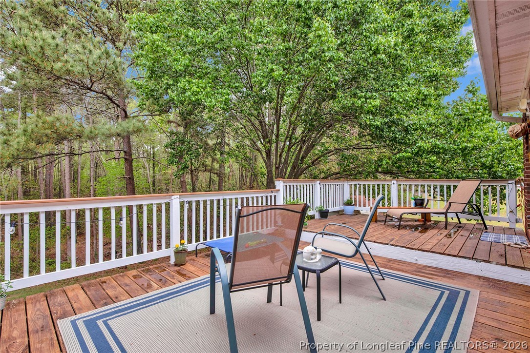 4425 Bishamon Street Hope Mills, NC 28348 - Photo 29 of 39 a roof deck with a table and chairs