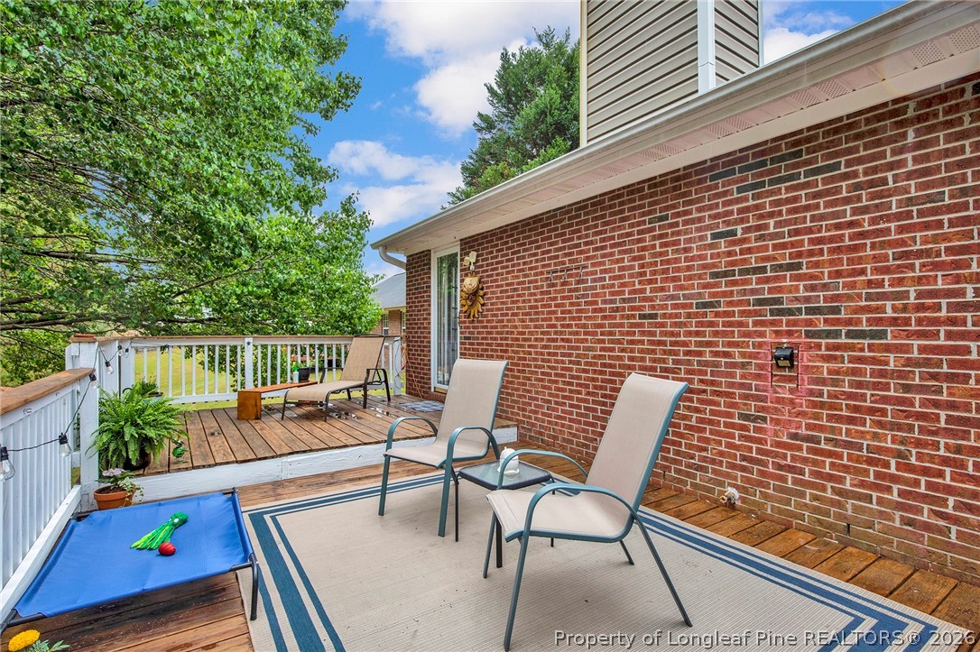 4425 Bishamon Street Hope Mills, NC 28348 - Photo 30 of 39 a balcony with chairs and wooden floor