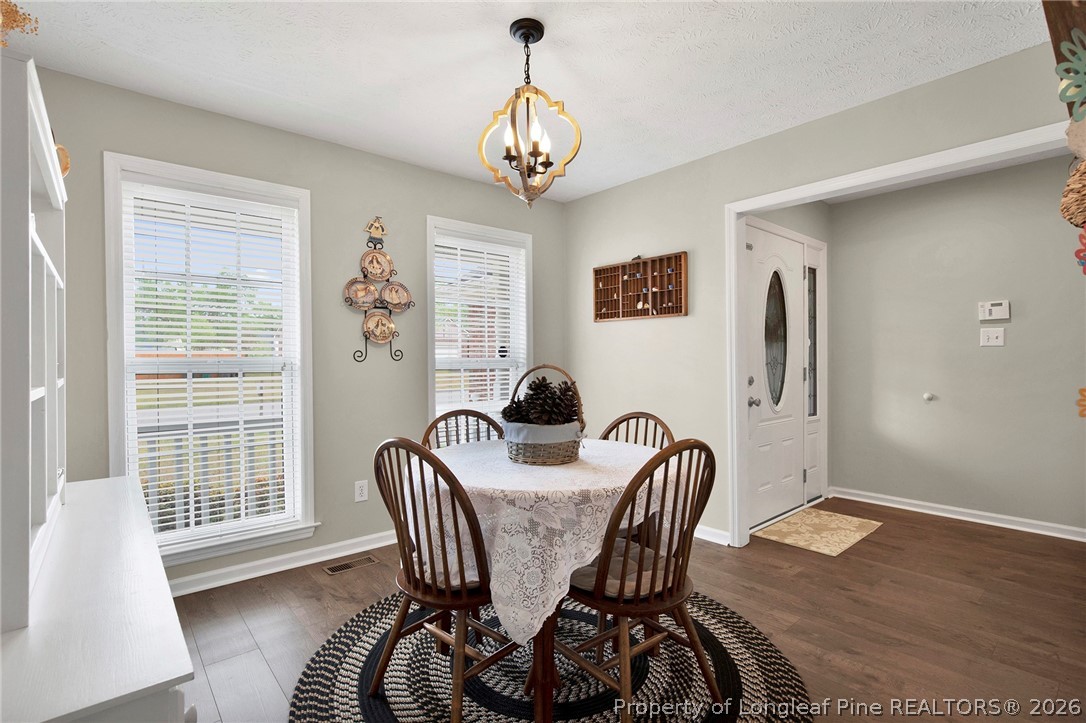 4425 Bishamon Street Hope Mills, NC 28348 - Photo 7 of 39 a view of a dining room with furniture window and wooden floor