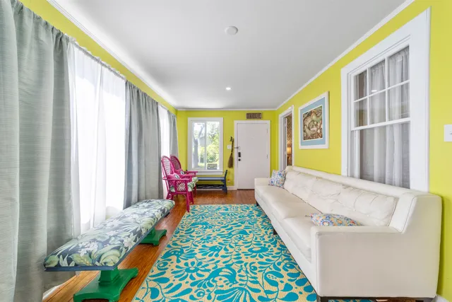 a bedroom with a bed and a flat tv screen on dresser