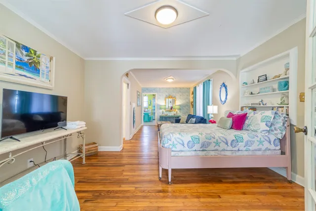 a living room with furniture a flat screen tv and a table