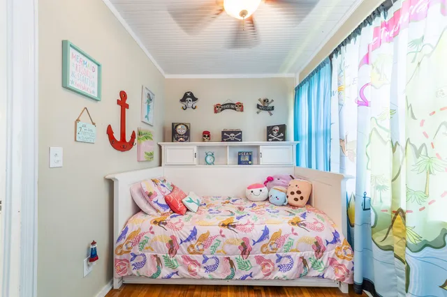 a front view of a house with garden and sitting area