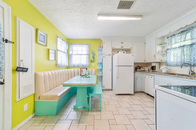 a front view of a house with yard and green space