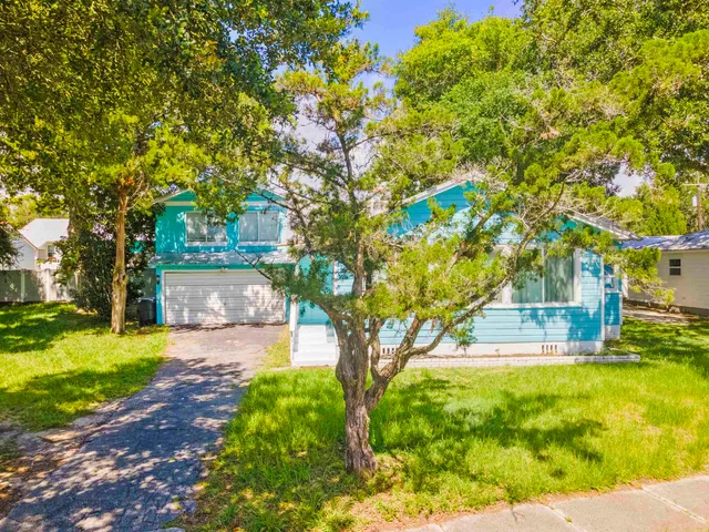 an aerial view of residential houses with outdoor space and river