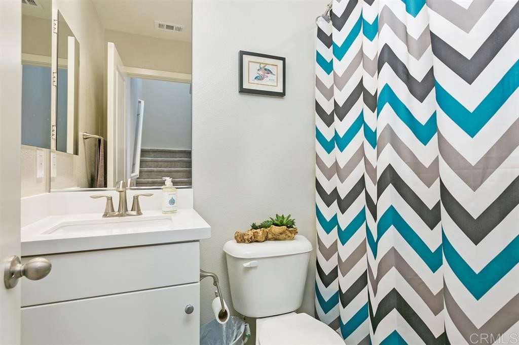 4222 Mission Ranch Way Oceanside, CA 92057 - Photo 13 of 22 a bathroom with a sink mirror vanity and toilet