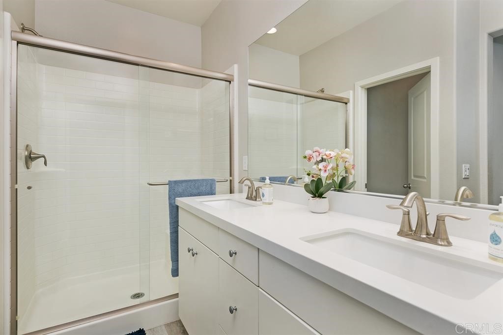 4222 Mission Ranch Way Oceanside, CA 92057 - Photo 16 of 22 a bathroom with a double vanity sink and a mirror