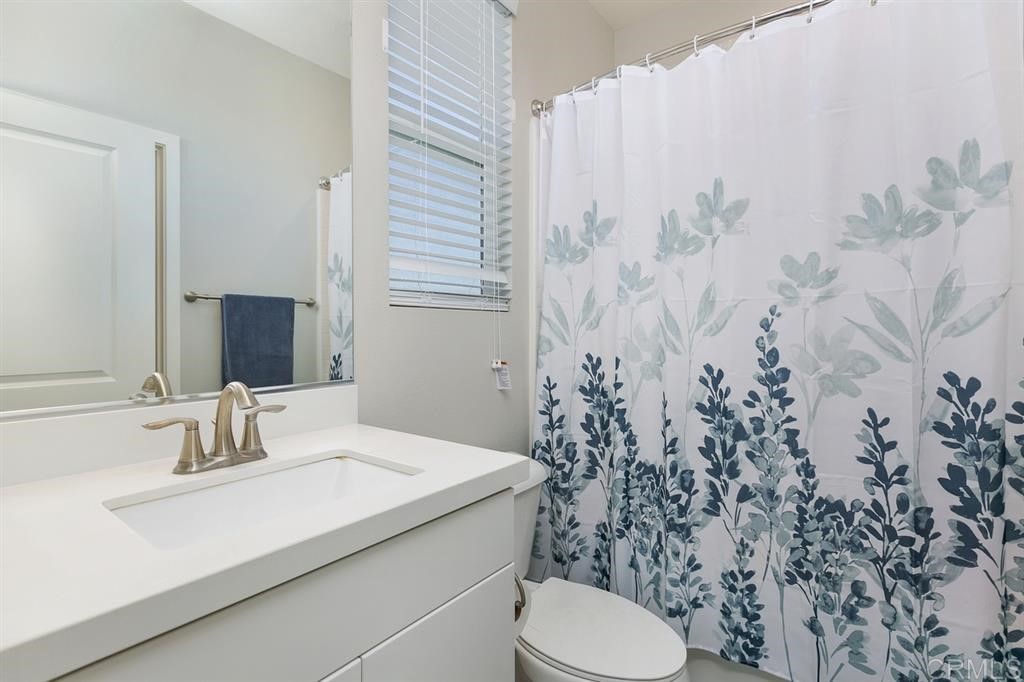 4222 Mission Ranch Way Oceanside, CA 92057 - Photo 18 of 22 a bathroom with a sink toilet and mirror