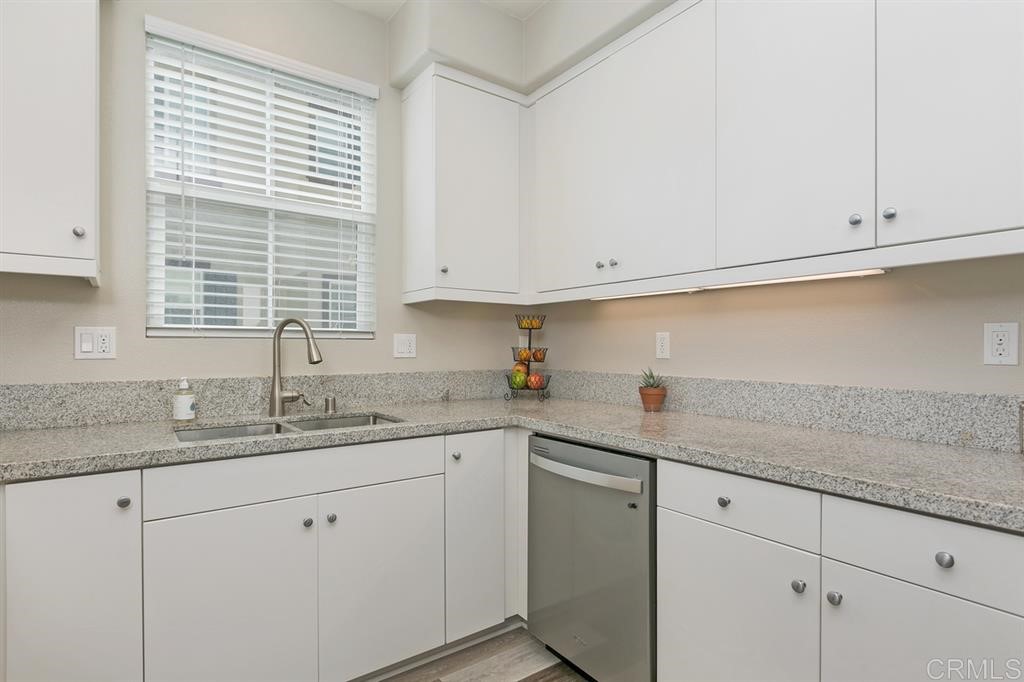 4222 Mission Ranch Way Oceanside, CA 92057 - Photo 10 of 22 a kitchen with granite countertop white cabinets and white stainless steel appliances