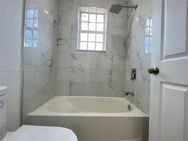 a bathroom with a bathtub and a toilet