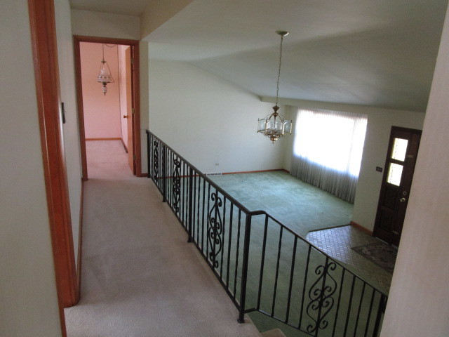18542 Bock Road Lansing, IL 60438 - Photo 3 of 30 a view of a hallway view with wooden floor and staircase