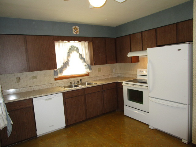 18542 Bock Road Lansing, IL 60438 - Photo 6 of 30 a kitchen with a white cabinets and white appliances