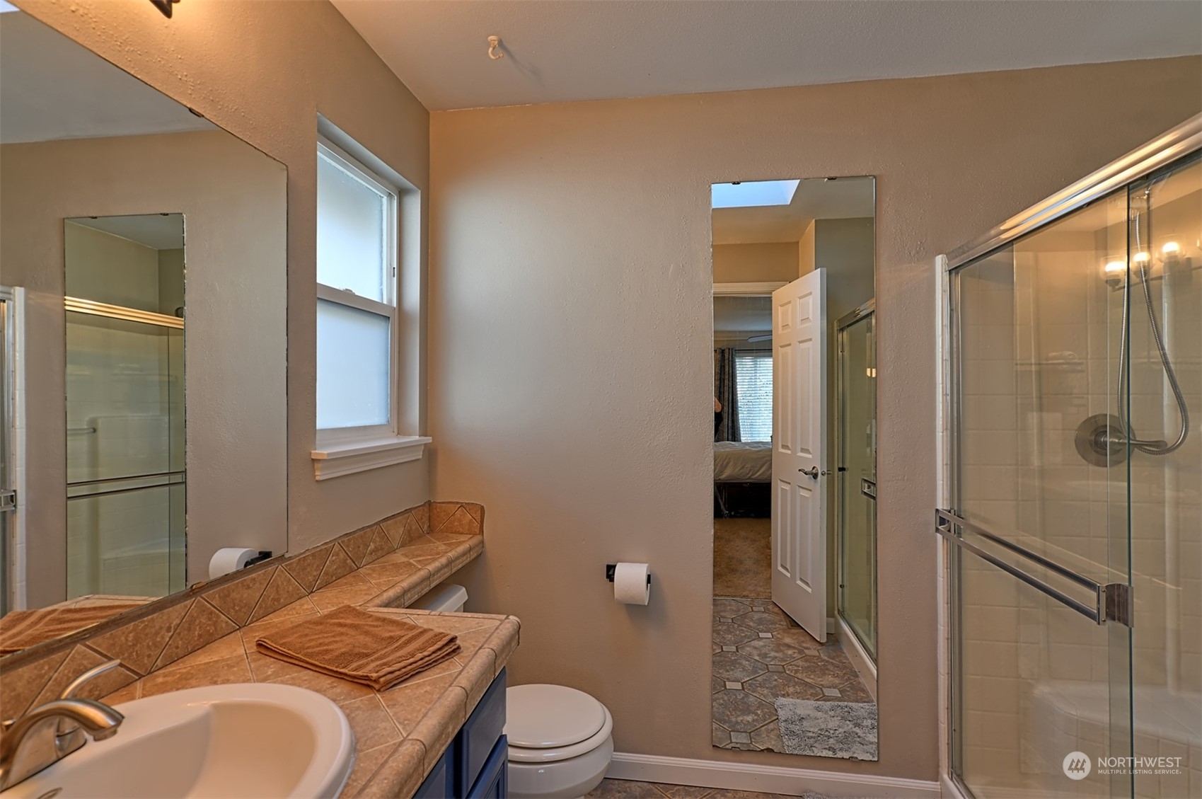 13438 Boulder Ridge Road Southeast Monroe, WA 98272 - Photo 21 of 30 a bathroom with a granite countertop sink toilet and shower