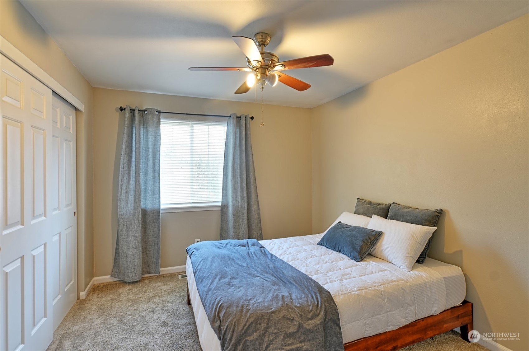 13438 Boulder Ridge Road Southeast Monroe, WA 98272 - Photo 24 of 30 a bedroom with a bed and a chandelier