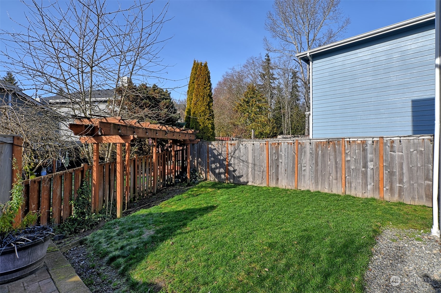 13438 Boulder Ridge Road Southeast Monroe, WA 98272 - Photo 26 of 30 a view of a backyard with wooden fence
