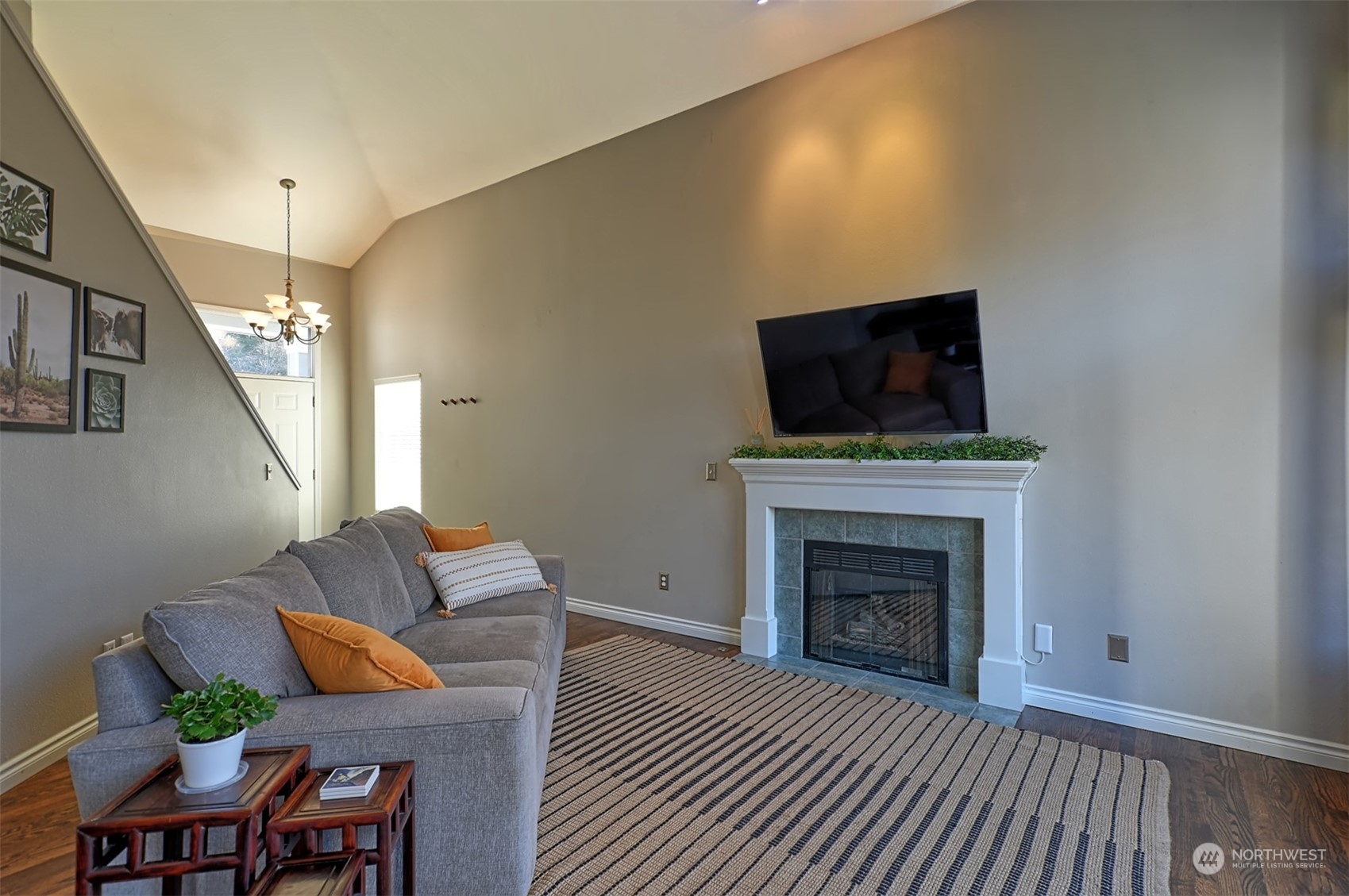 13438 Boulder Ridge Road Southeast Monroe, WA 98272 - Photo 4 of 30 a living room with furniture a fireplace and a flat screen tv