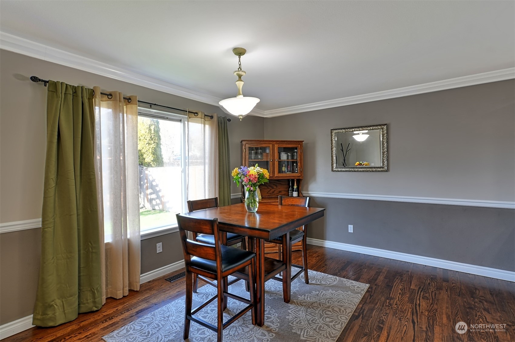 13438 Boulder Ridge Road Southeast Monroe, WA 98272 - Photo 8 of 30 a view of a dining room with furniture a chandelier and wooden floor
