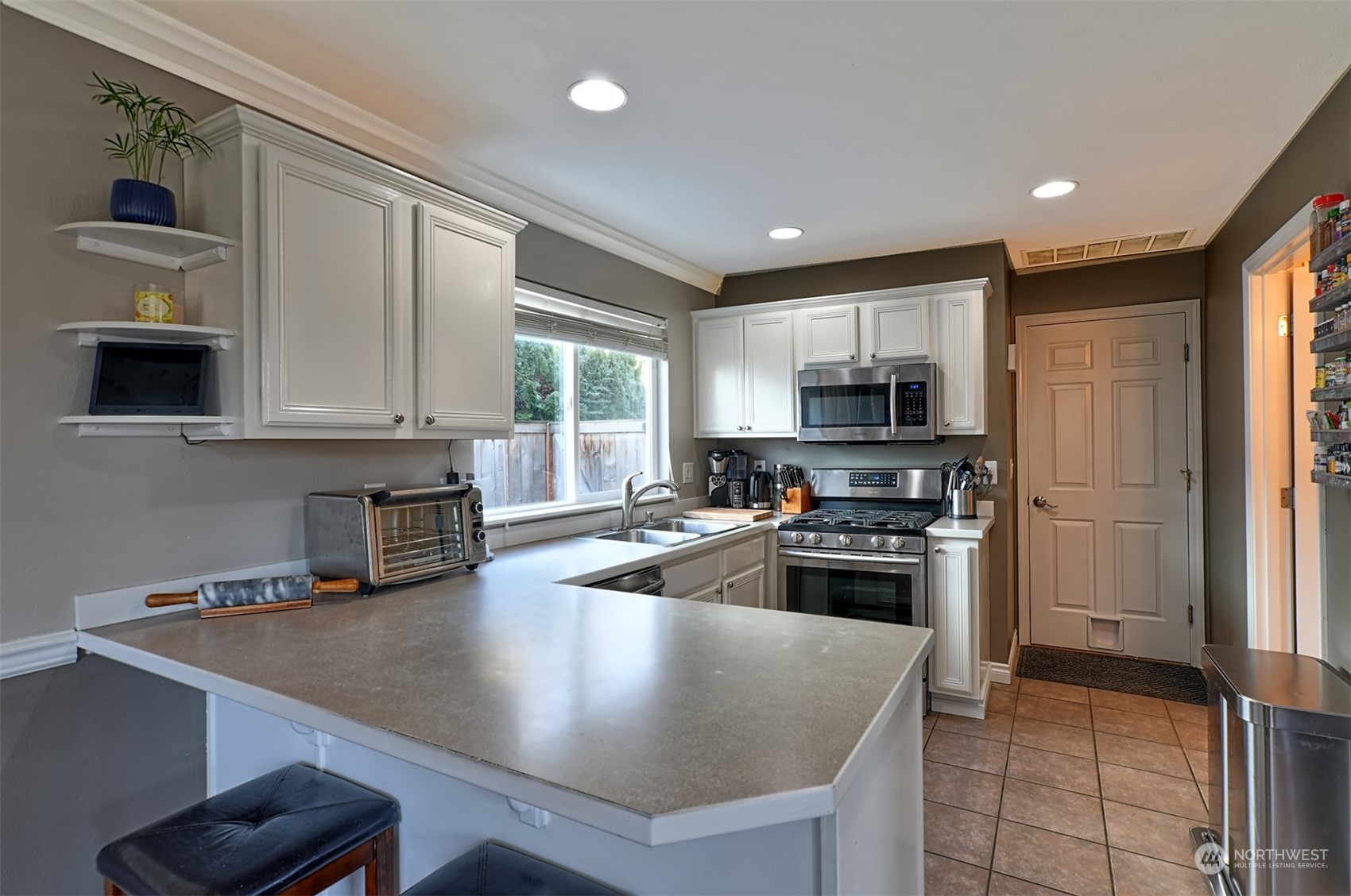 13438 Boulder Ridge Road Southeast Monroe, WA 98272 - Photo 10 of 30 a kitchen with granite countertop a stove sink and refrigerator