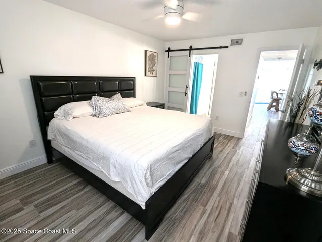 a large bed sitting in a bedroom and a chandelier