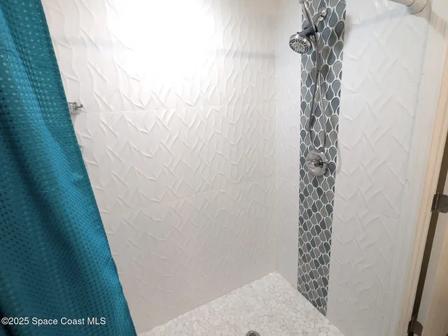 a bathroom with a toilet and a mirror