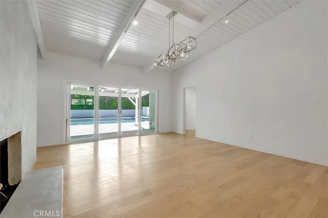 a kitchen with stainless steel appliances granite countertop a sink and a refrigerator