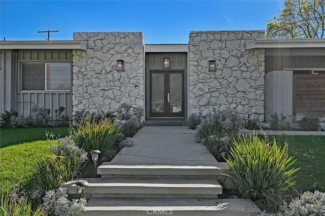 a living room with a mirror and a window