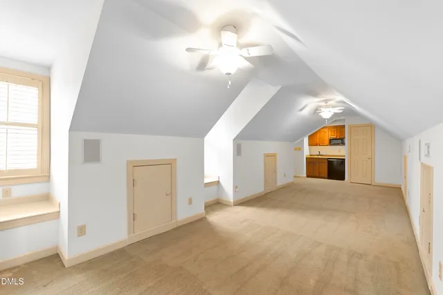 a living room filled with furniture and a potted plant