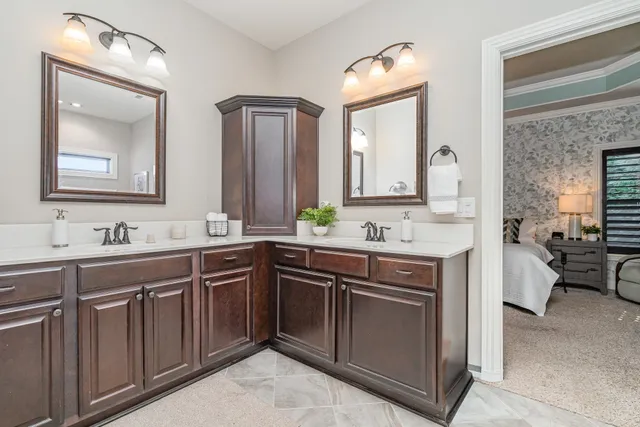 a spacious bathroom with a double vanity sink and a mirror