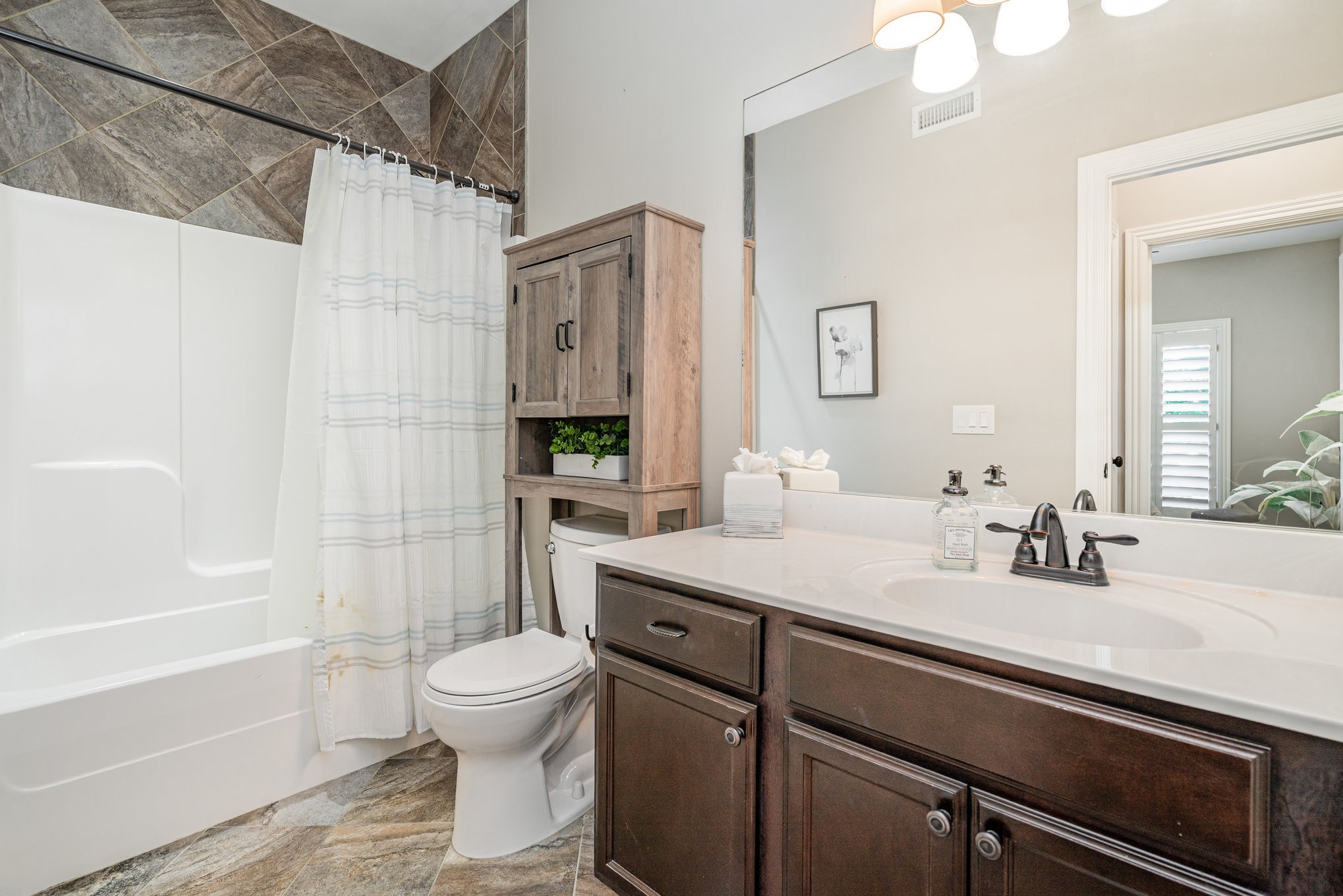 5227 Starnes Drive Murfreesboro, TN 37128 - Photo 15 of 27 a bathroom with a sink a toilet and a bathtub