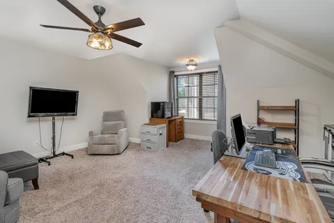 a bedroom with a bed and a potted plant