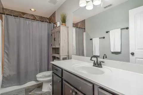 a backyard of a house with a table and chairs