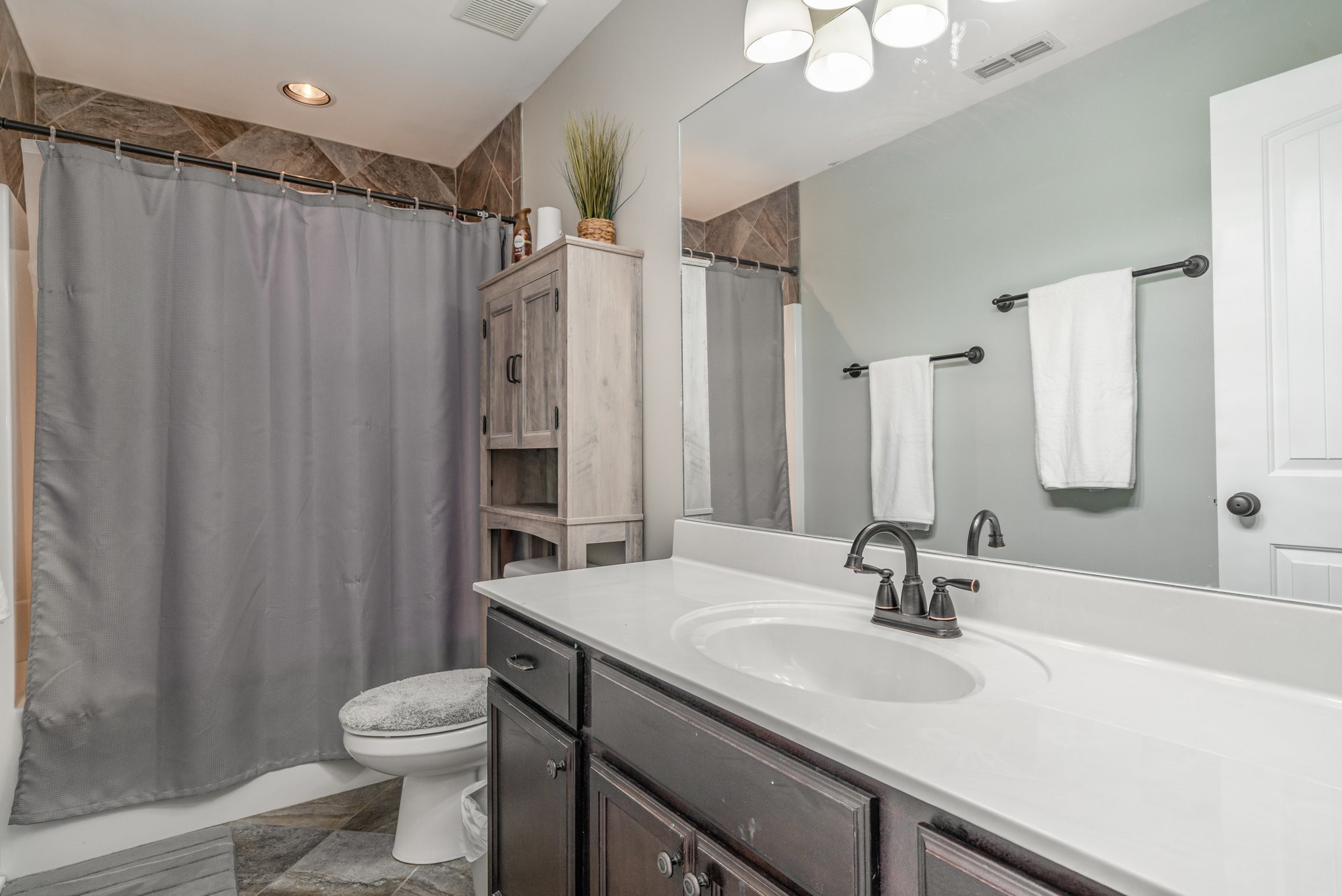 5227 Starnes Drive Murfreesboro, TN 37128 - Photo 24 of 29 a bathroom with a double vanity sink toilet and a mirror