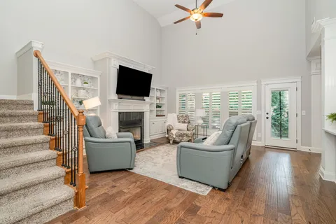 a living room with furniture a flat screen tv and a fireplace
