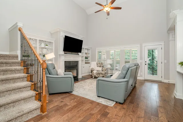 a living room with furniture a flat screen tv and a fireplace