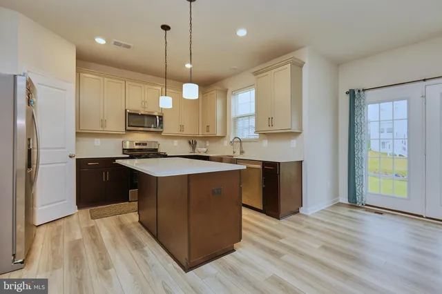 a kitchen with granite countertop a stove and a microwave