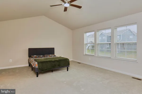 a bedroom with a bed and a ceiling fan
