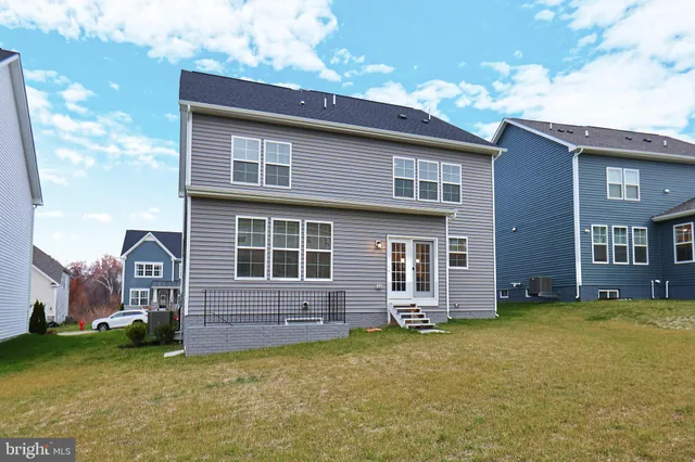 a view of a patio with a table and chairs potted plants