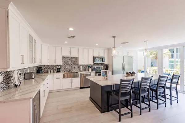 a large kitchen with a table and chairs