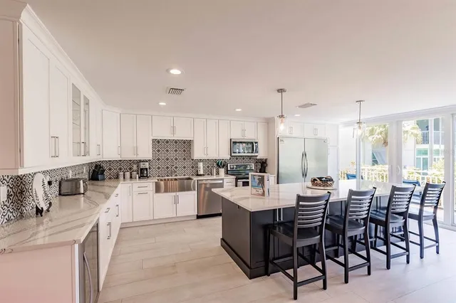 a large kitchen with a table and chairs
